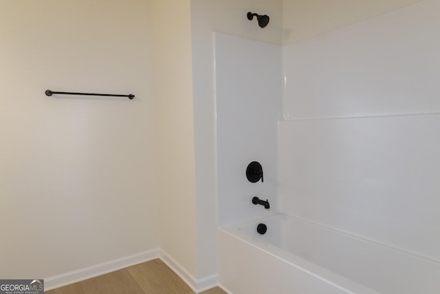 bathroom with shower / bath combination and wood-type flooring