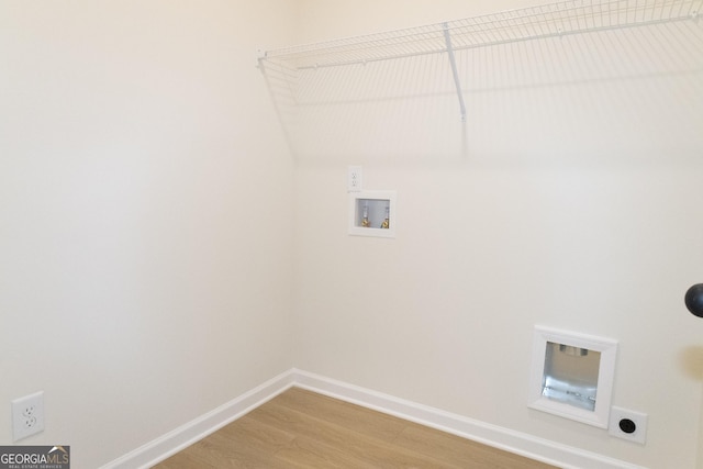 laundry room featuring electric dryer hookup, hookup for a washing machine, and hardwood / wood-style floors