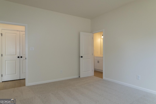 unfurnished room with light carpet