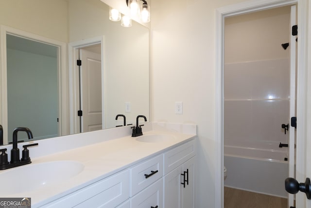 bathroom with hardwood / wood-style floors, vanity, and toilet