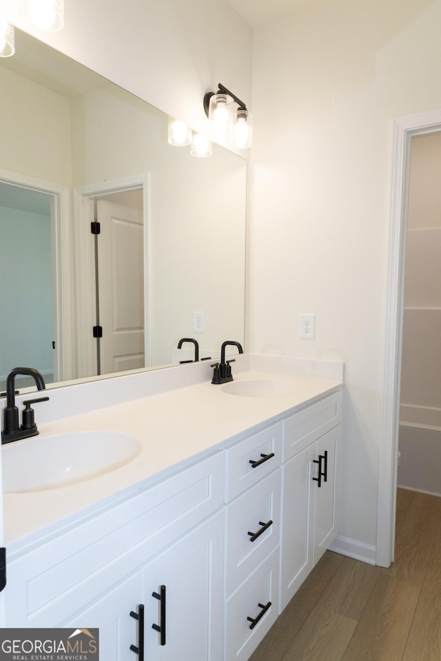 bathroom with vanity and hardwood / wood-style flooring