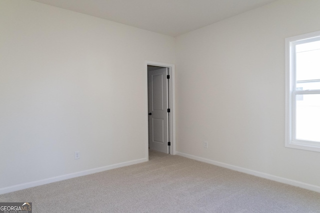 carpeted spare room featuring a wealth of natural light