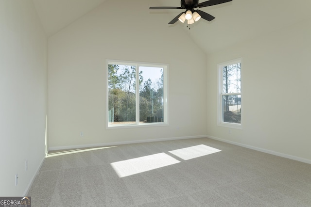 empty room with ceiling fan, carpet floors, and high vaulted ceiling