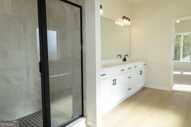 bathroom featuring a shower with door, vanity, and hardwood / wood-style flooring