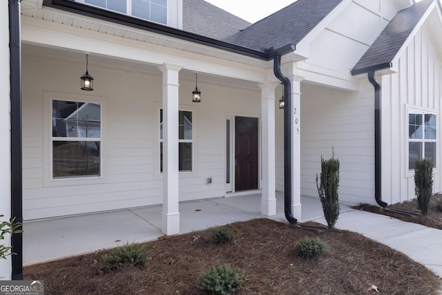 view of exterior entry with covered porch