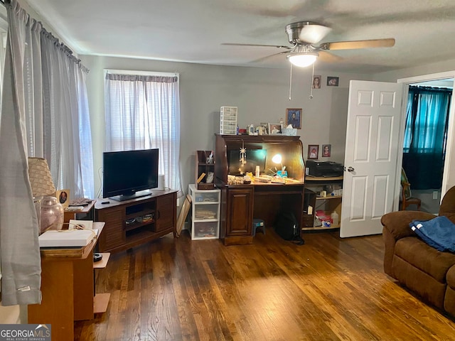 office area with ceiling fan and dark wood-type flooring