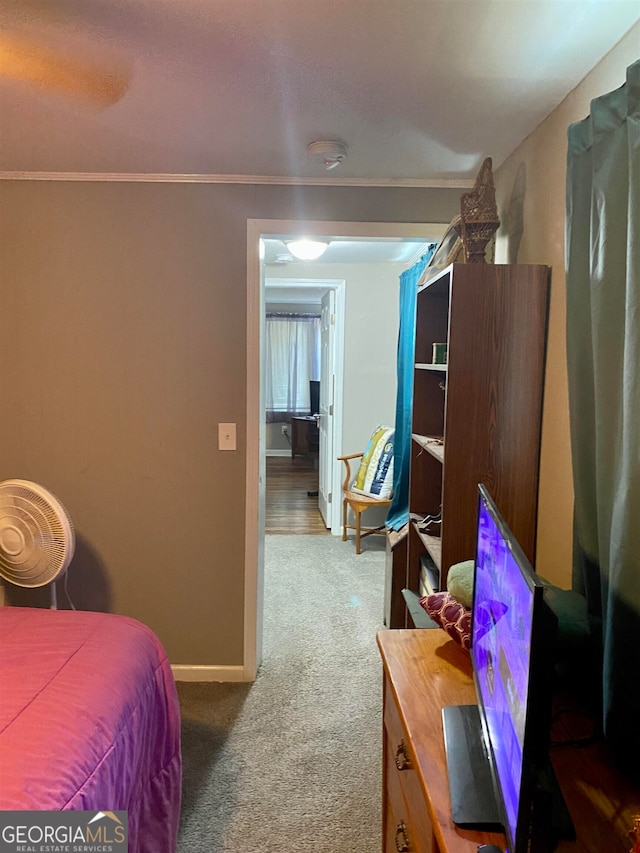 carpeted bedroom featuring crown molding