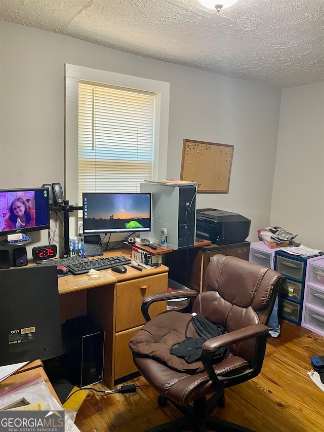 office featuring a textured ceiling and hardwood / wood-style flooring