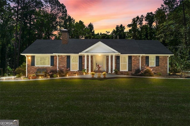 ranch-style house featuring a yard