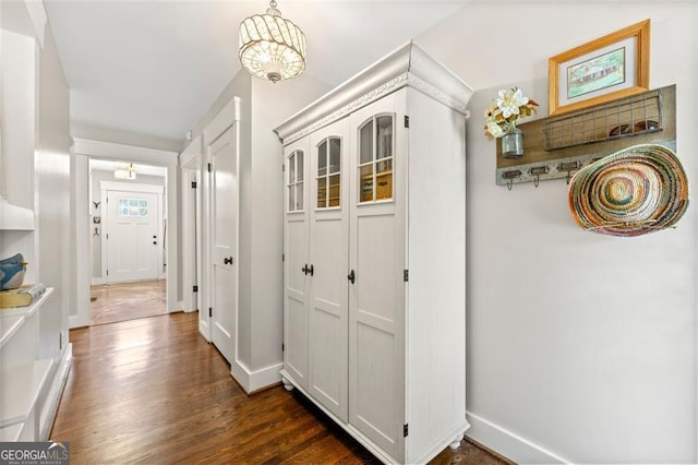 corridor with dark hardwood / wood-style flooring