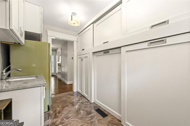 mudroom with sink and dark wood-type flooring