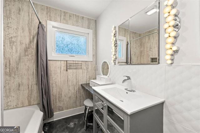 bathroom featuring tile walls, vanity, and shower / tub combo