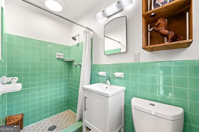 bathroom featuring tile walls, vanity, curtained shower, and toilet