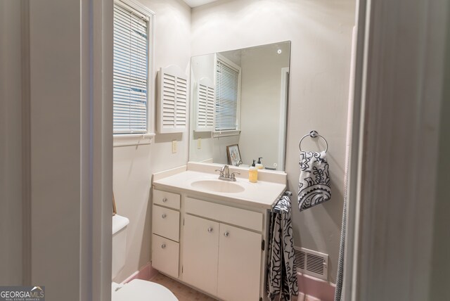 bathroom featuring vanity and toilet