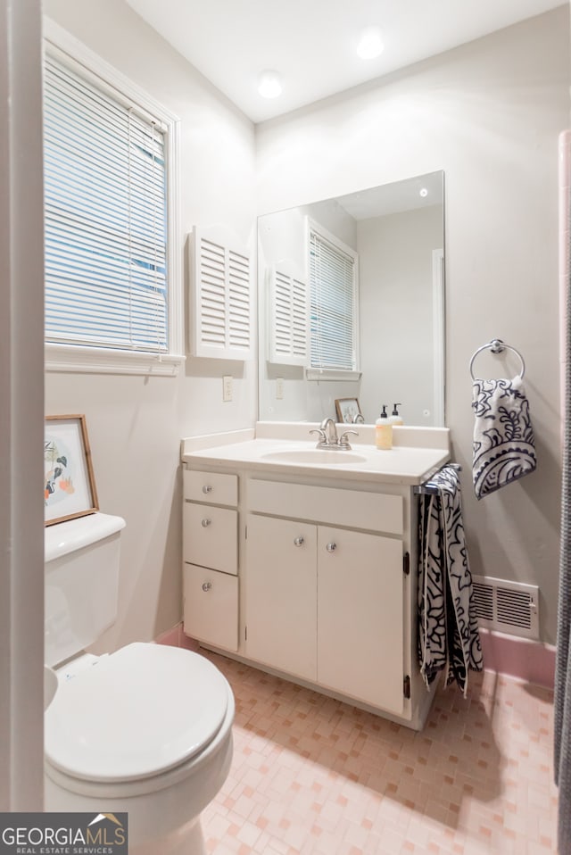 bathroom with vanity and toilet