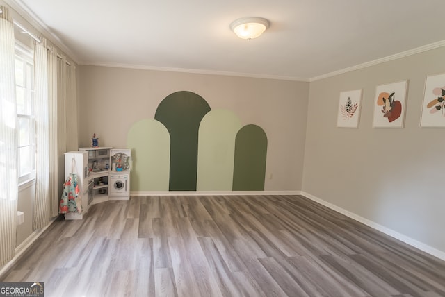 spare room with crown molding and hardwood / wood-style floors