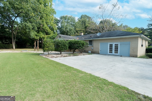 exterior space with a front yard and french doors