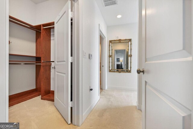 hall featuring baseboards, visible vents, carpet flooring, and recessed lighting