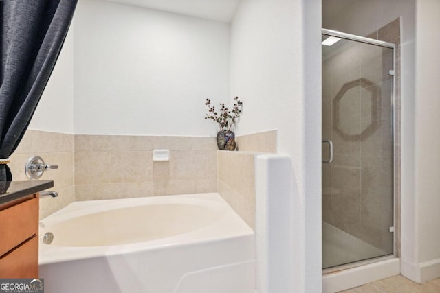 bathroom featuring a shower stall, a bath, and vanity