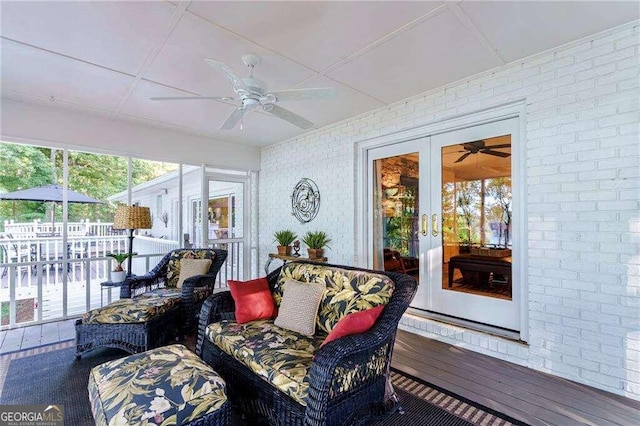 sunroom featuring ceiling fan