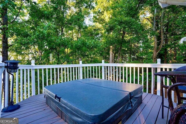 wooden deck with a covered hot tub