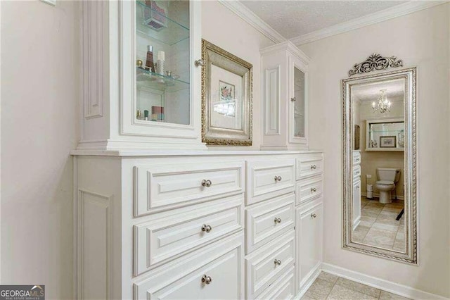 bathroom with ornamental molding, tile patterned floors, vanity, and toilet