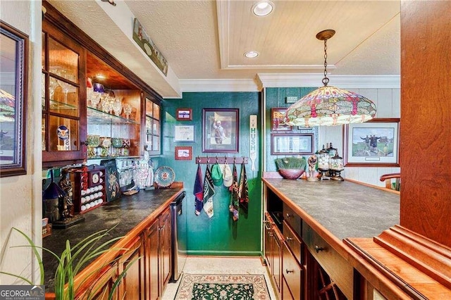 bar with pendant lighting, a textured ceiling, ornamental molding, and stainless steel dishwasher