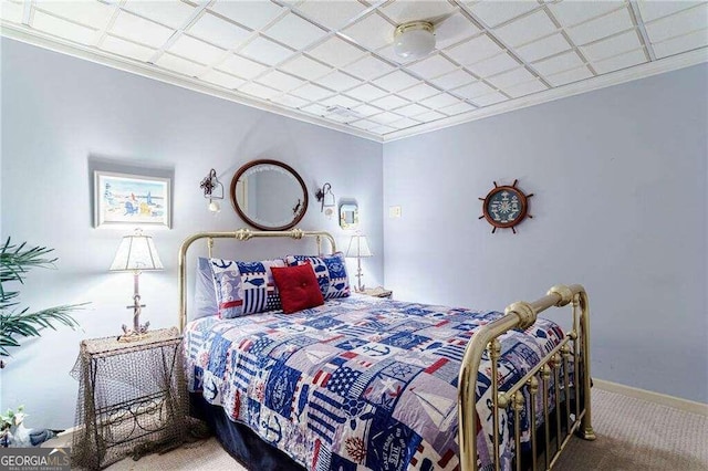 bedroom with crown molding and carpet flooring