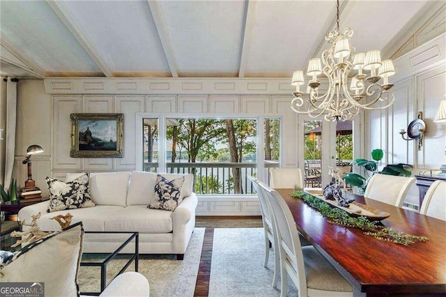 sunroom / solarium with lofted ceiling with beams and an inviting chandelier