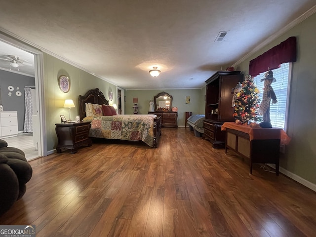 bedroom with crown molding and dark wood-type flooring