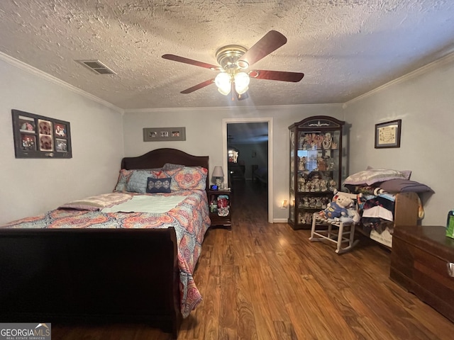 bedroom featuring crown molding, ceiling fan, hardwood / wood-style flooring, and a textured ceiling