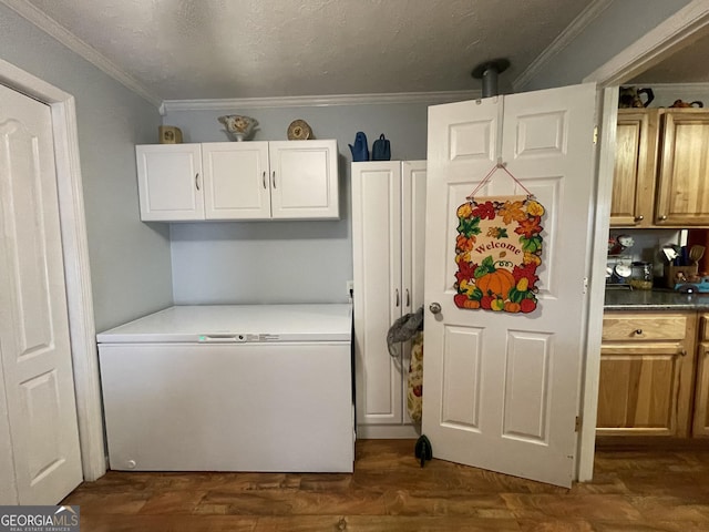 kitchen with crown molding, fridge, white cabinets, and dark hardwood / wood-style flooring