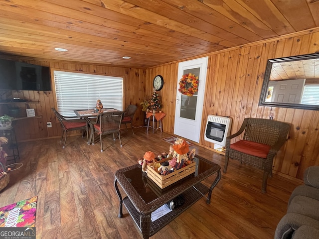 living room featuring hardwood / wood-style floors, heating unit, wooden ceiling, and wood walls