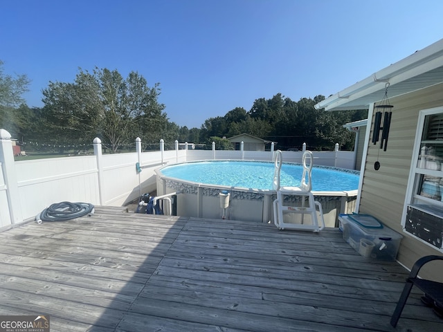 view of swimming pool featuring a wooden deck