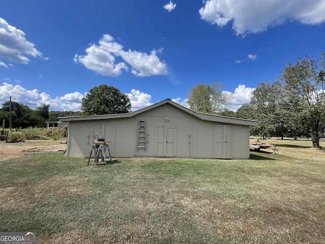 view of property exterior featuring a storage shed and a lawn