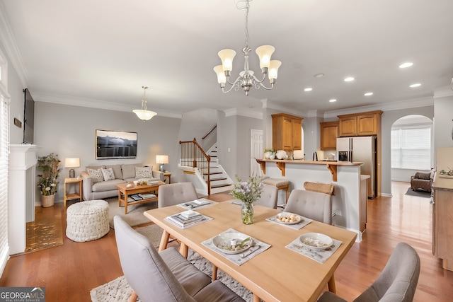 dining room featuring a notable chandelier, crown molding, and light hardwood / wood-style floors