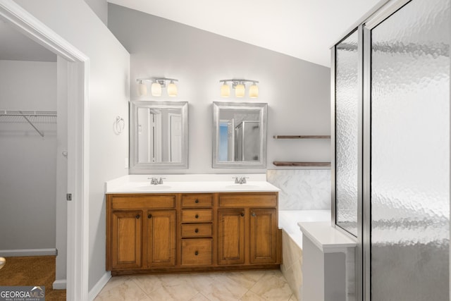 bathroom featuring walk in shower, vanity, and vaulted ceiling