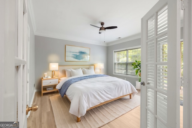 bedroom with ceiling fan, ornamental molding, and light wood-type flooring