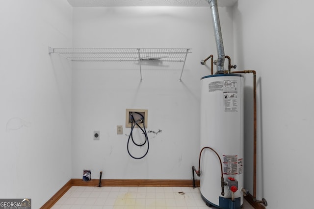 laundry area with hookup for a washing machine, water heater, and hookup for an electric dryer