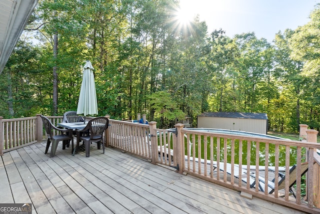 wooden deck featuring a storage unit