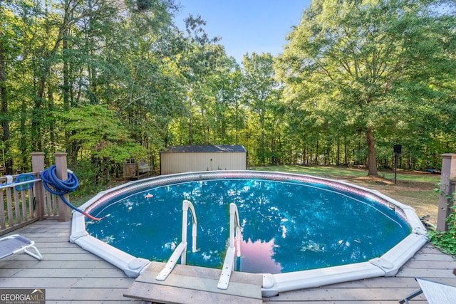 view of swimming pool featuring a deck and a storage unit