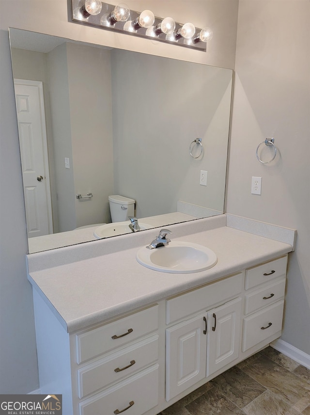 bathroom featuring vanity and toilet