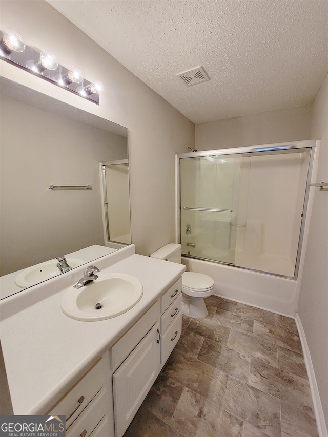 full bathroom with vanity, toilet, a textured ceiling, and combined bath / shower with glass door