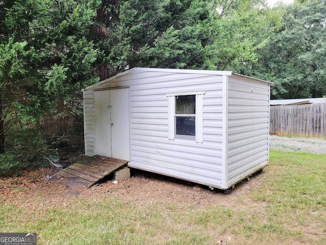 view of outbuilding with a lawn