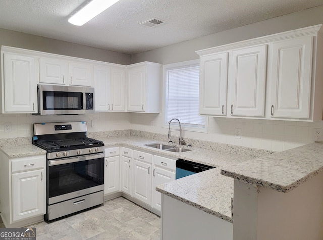 kitchen with appliances with stainless steel finishes, white cabinetry, backsplash, kitchen peninsula, and sink