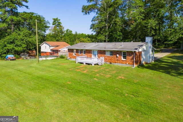 back of house featuring a lawn