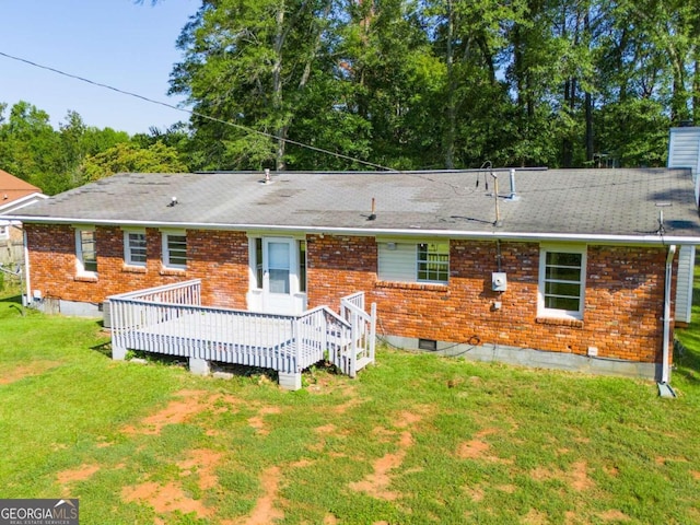 back of house featuring a yard and a deck