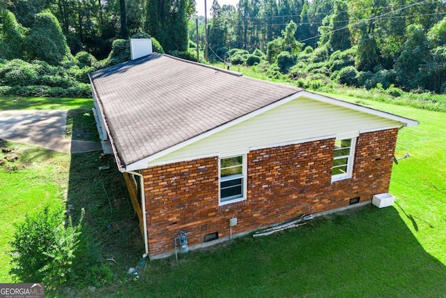 view of home's exterior with a yard