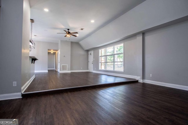 unfurnished living room featuring vaulted ceiling, dark hardwood / wood-style floors, and ceiling fan