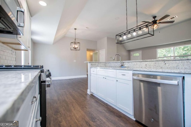 kitchen with ceiling fan, appliances with stainless steel finishes, light stone counters, and white cabinetry